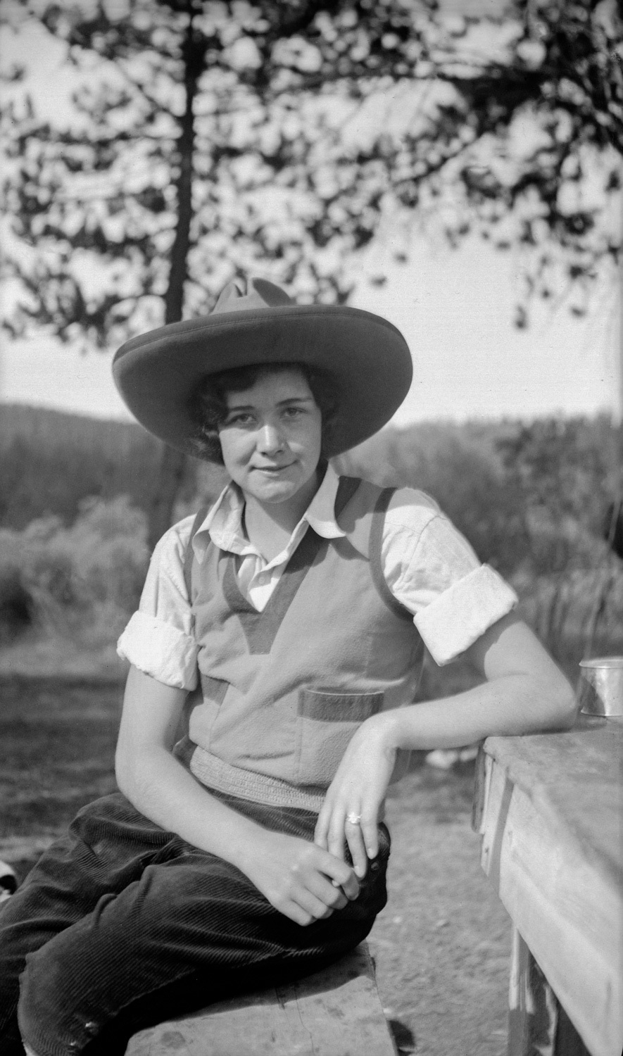 Black and white photo of a young woman dressed in U.S. western garb